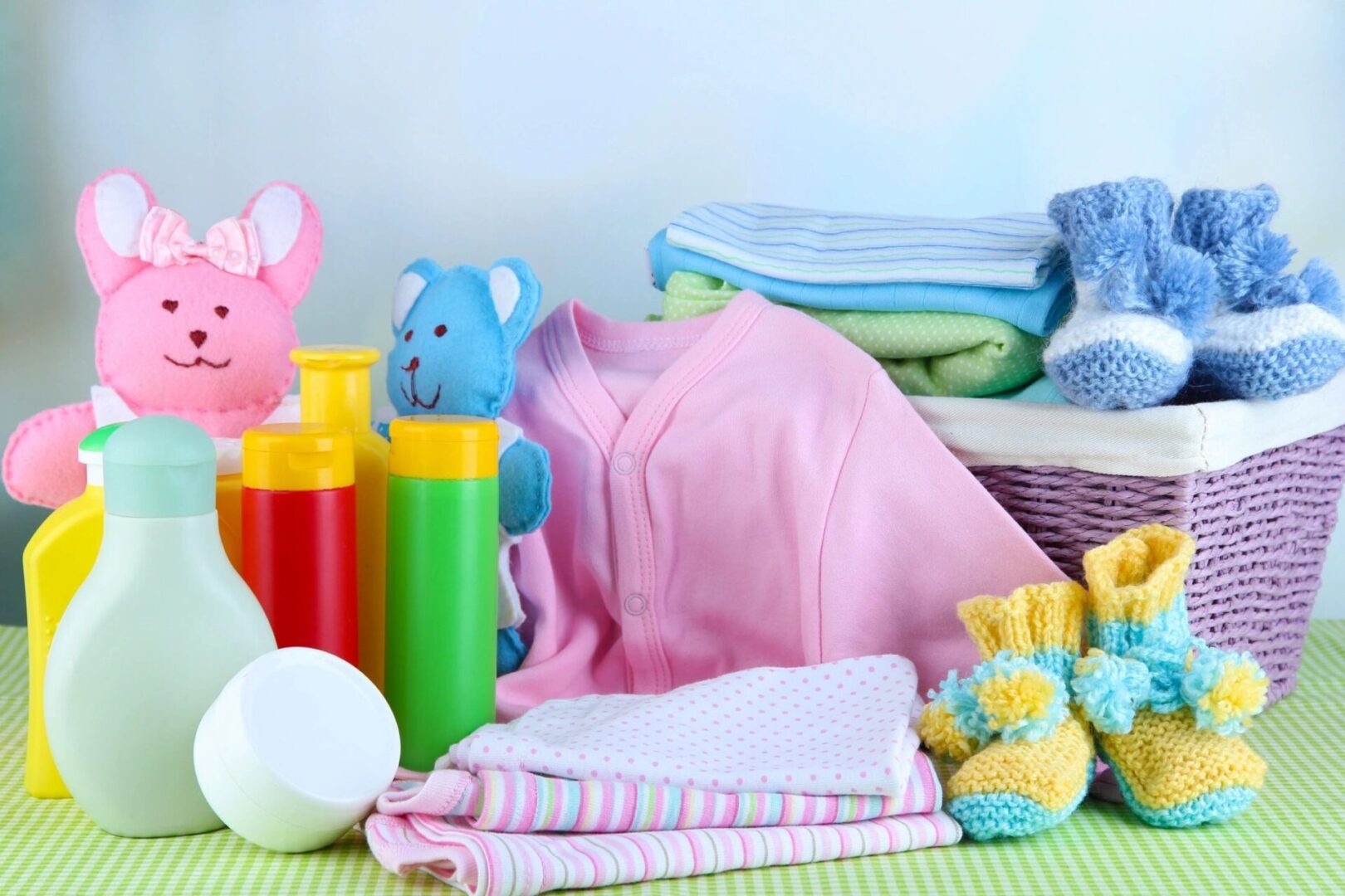 A pile of baby items sitting on top of a table.