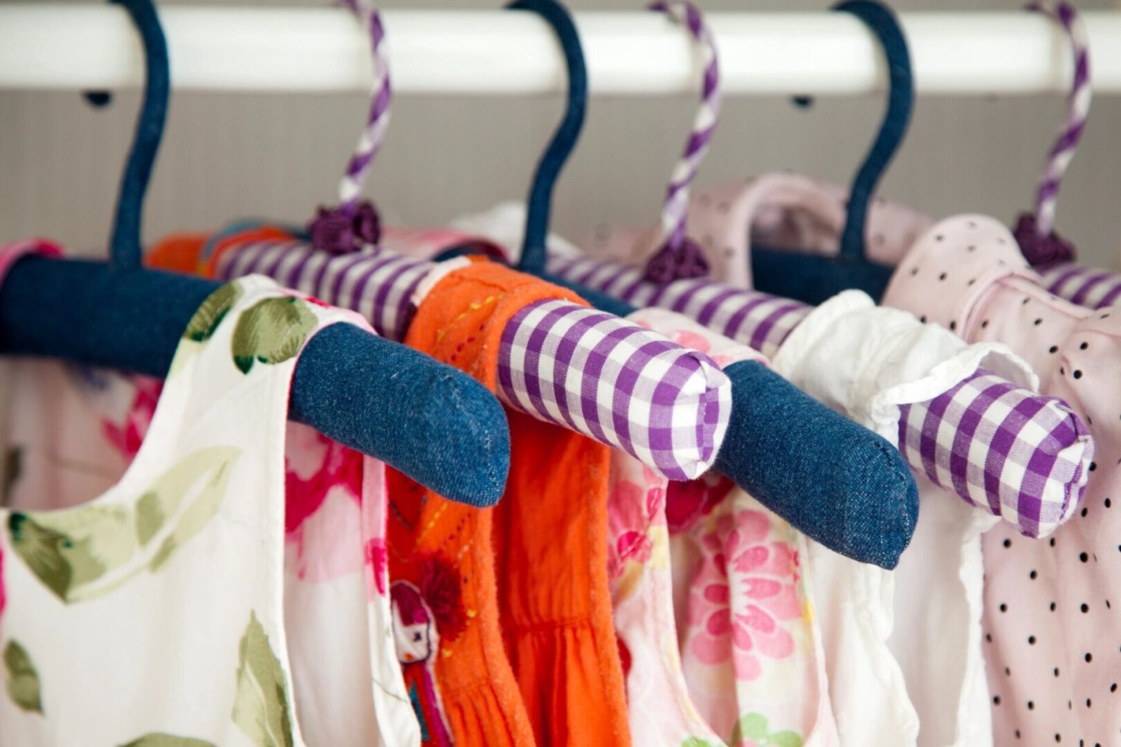 A close up of clothes hanging on hangers